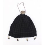 Lady's crochet handbag with expanding metal top and clear and black glass tassels, 30cms tall