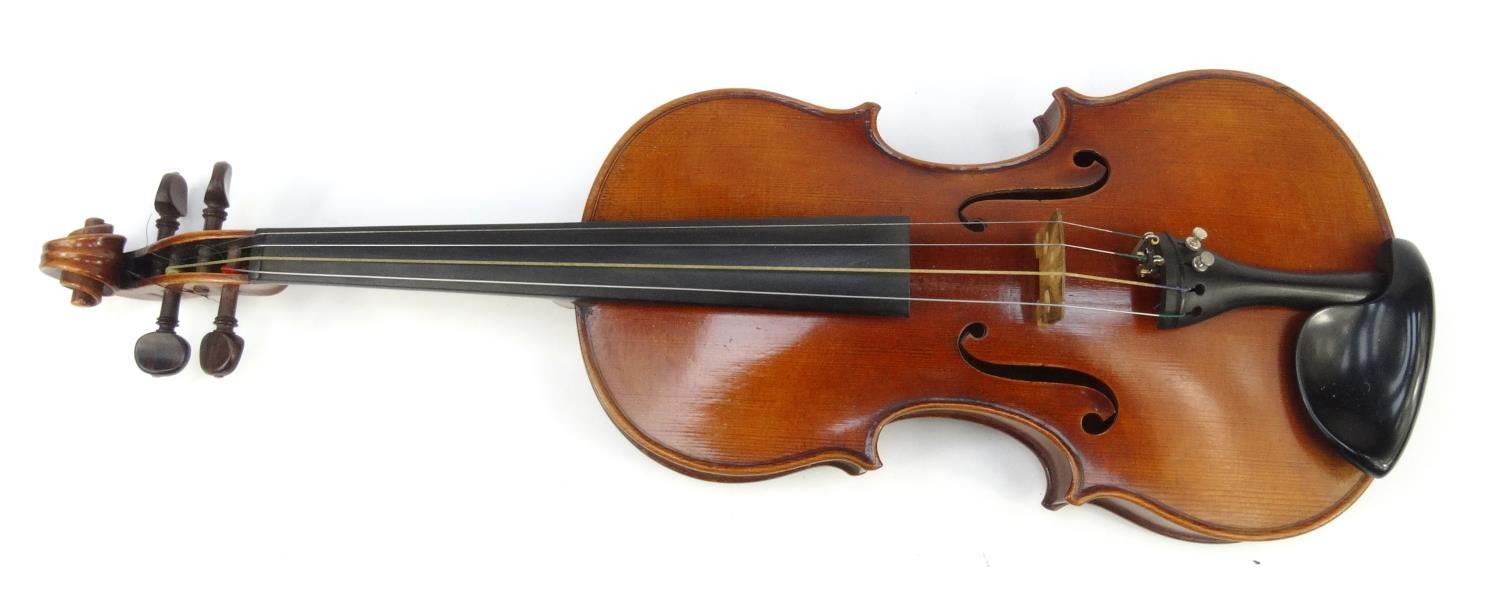 Cased wooden violin with paper label 'Paolo Fiorini Taurini 1928', the back 37cm long