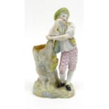 Continental hand painted porcelain model of a young boy, blue initial to base, 20cm high In