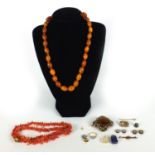 Assorted jewellery including amber coloured bead necklace, coral necklace, gilt metal studs,