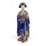 Japanese Kutani pottery figure of a geisha girl in a blue robe decorated with butterflies and