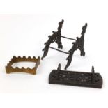 Two Victorian cast iron pen stands and a brass example, the largest 12cms high