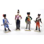 Four military interest hand painted Continental porcelain models of soldiers, the largest 28cm high