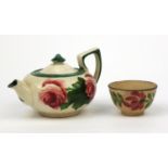 Welsh Llanelly pottery teapot hand painted with roses, together with a similar tea bowl, the