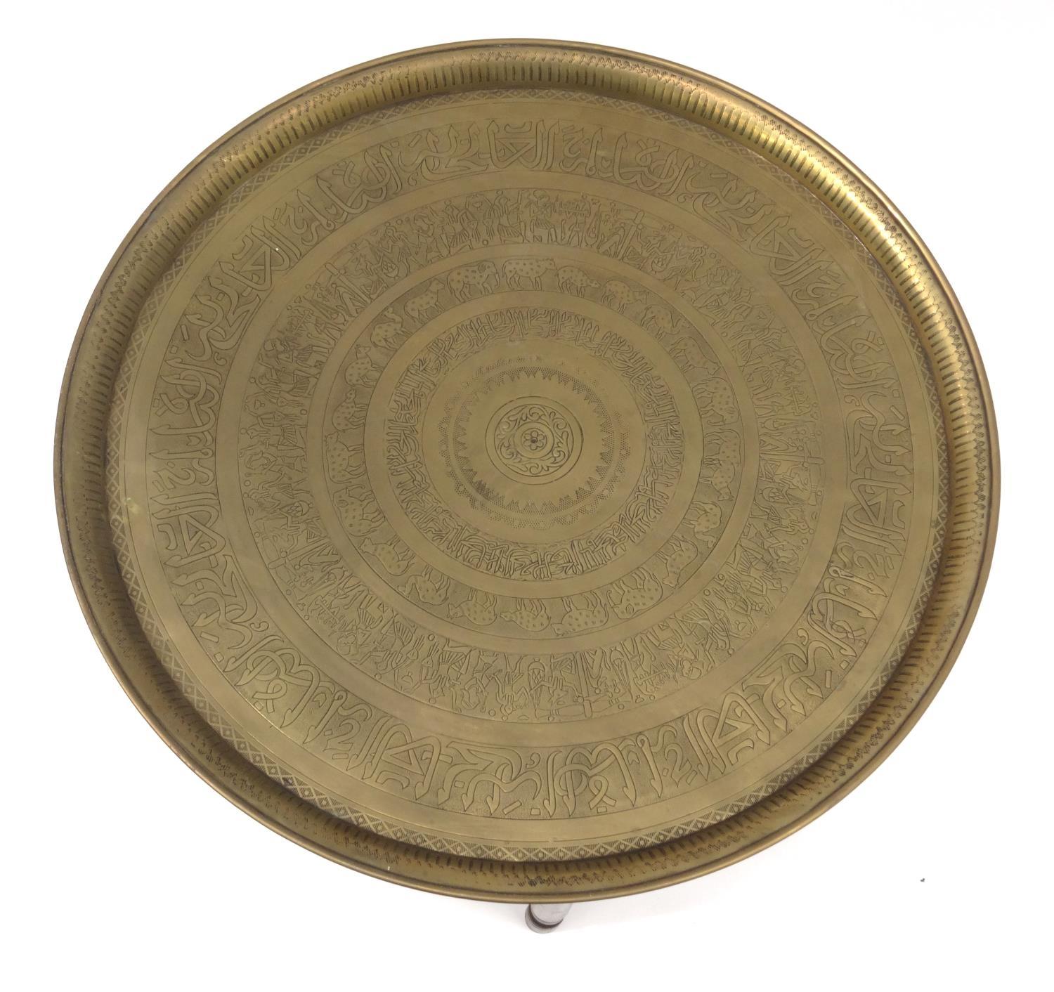 Middle Eastern brass tray topped circular occasional table decorated with figures and script, the - Image 4 of 9