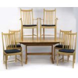 Ercol elm extending dining table, together with six chairs including two carvers, with blue