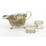 Silver sauce boat, together with two silver napkin rings, the sauce boat 8cm high