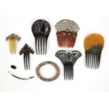 Selection of lady's hair slides including horn example and Victorian ruby glass example, the largest