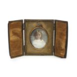 Hand painted portrait miniature onto porcelain of a young girl, housed in a leather case, mounted,