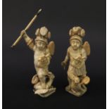 Pair of Continental carved ivory winged figures of soldiers, the largest 18cm high