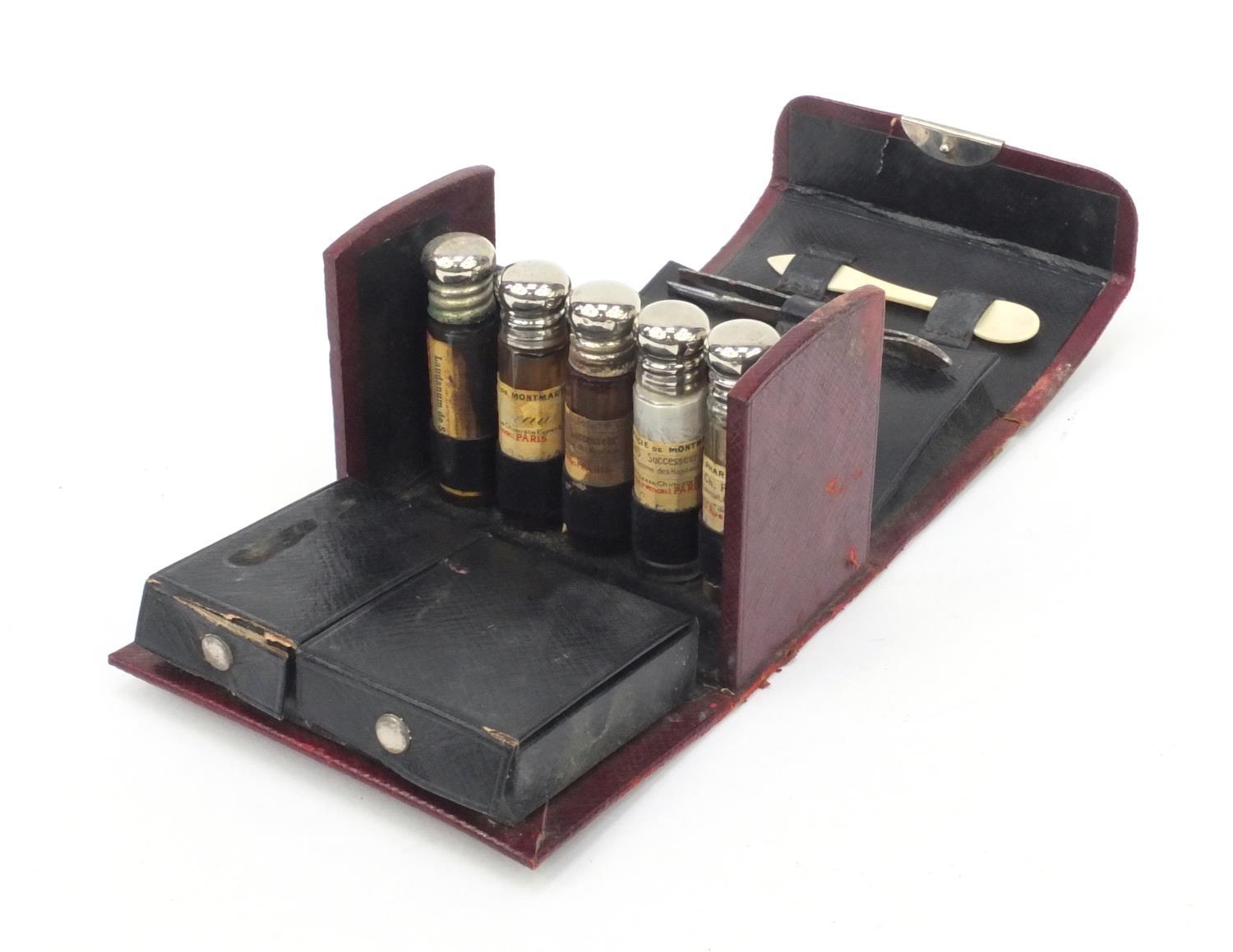 French doctor's red leather travelling case housing a selection of glass bottles, spoon, penknife