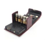 French doctor's red leather travelling case housing a selection of glass bottles, spoon, penknife