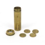 Selection of intaglio moulded brass weights housed in a brass tube, the tube 5.5cm high