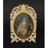 Impressive European ivory easel photo frame carved with 'C' scrolls and flowers housing a hand
