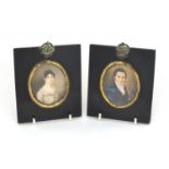 Pair of 19th century oval portrait miniatures, one of a gentleman wearing a blue coat, the other