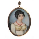 19th century oval portrait miniature of a lady wearing a coral necklace onto ivory, housed in an