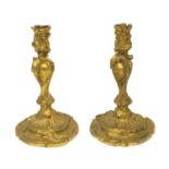 Pair of 19th century Rococo style ormolu candlesticks with scroll and acanthus decoration, each 24cm