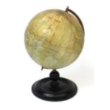 Philips 9inch terrestrial globe for the London Geographical Institute, with brass arch and turned