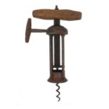 19th century steel four pillar corkscrew with cast iron ratchet sidearm and wooden handle, 20cm when