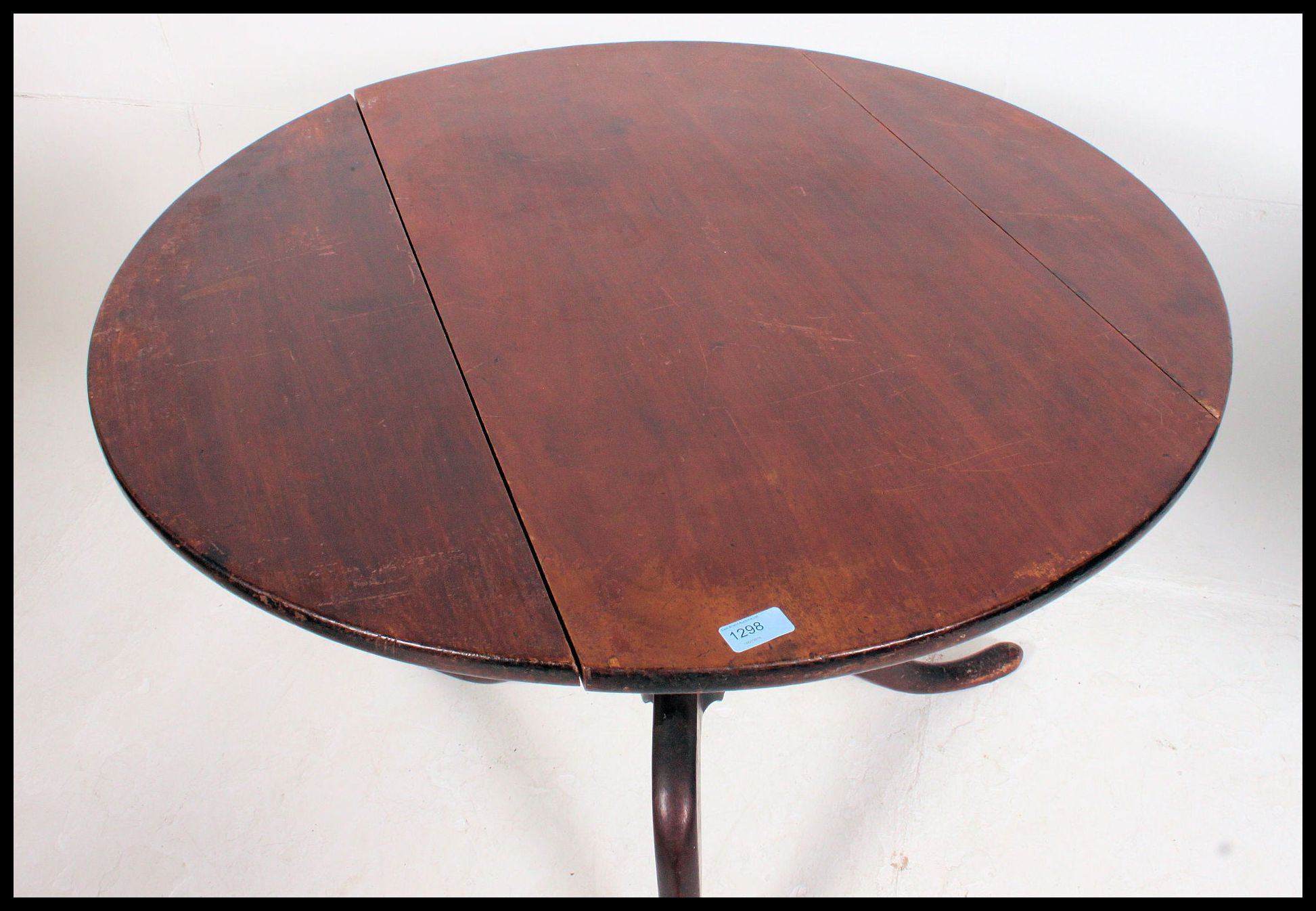 A 19th century Georgian mahogany tilt top dining table being converted one side to drop leaf. - Image 3 of 4