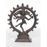 A 20th century oriental bronze figure of a deity raised on a plinth base with flaming circle