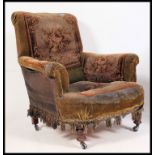 A Victorian tapestry upholstered chesterfield armchair in the manner of Howard & Sons.