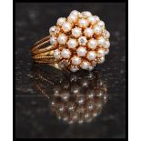 A stunning 18 / 22ct gold, diamond and seed pearl cluster ring.