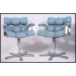 A pair of retro 1970's chrome and blue vinyl upholstered offie swivel chairs.