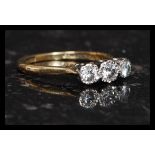 An early 20th century 3 stone 18ct gold and platinum diamond ring marked for Bravingtons.