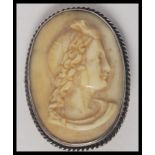 A Victorian Ivory / Bone cameo carved with the Head of a Bacchante mounted on a silver metal brooch