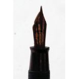 A 1936  Canadian striped gold Parker Vacumatic fountain pen with arrow parker nib.