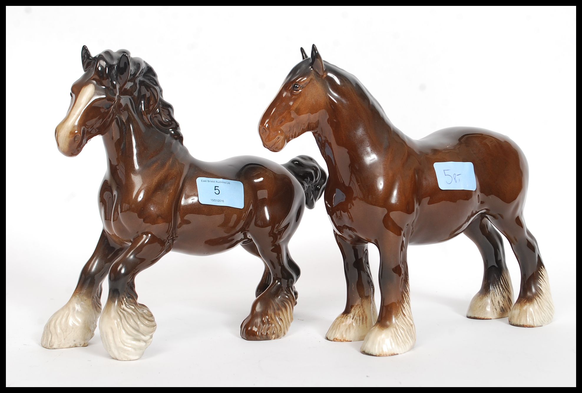 Two Beswick ceramic shire horse figurines each with a gloss brown finish bearing Beswick England