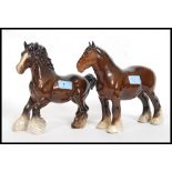 Two Beswick ceramic shire horse figurines each with a gloss brown finish bearing Beswick England