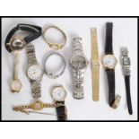 A collection of watches to include a vintage Timex wristwatch with black face and date aperture.