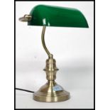 A 20th century contemporary antique style brass effect bankers desk top lamp with angular green