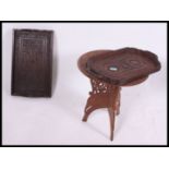 A profusely carved Kashmiri hardwood tray together with another, each of rectangular form.