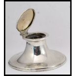 A solid silver hallmarked desk top inkwell complete with the original clear glass liner within