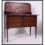 An Edwardian mahogany inlaid marble top washstand.