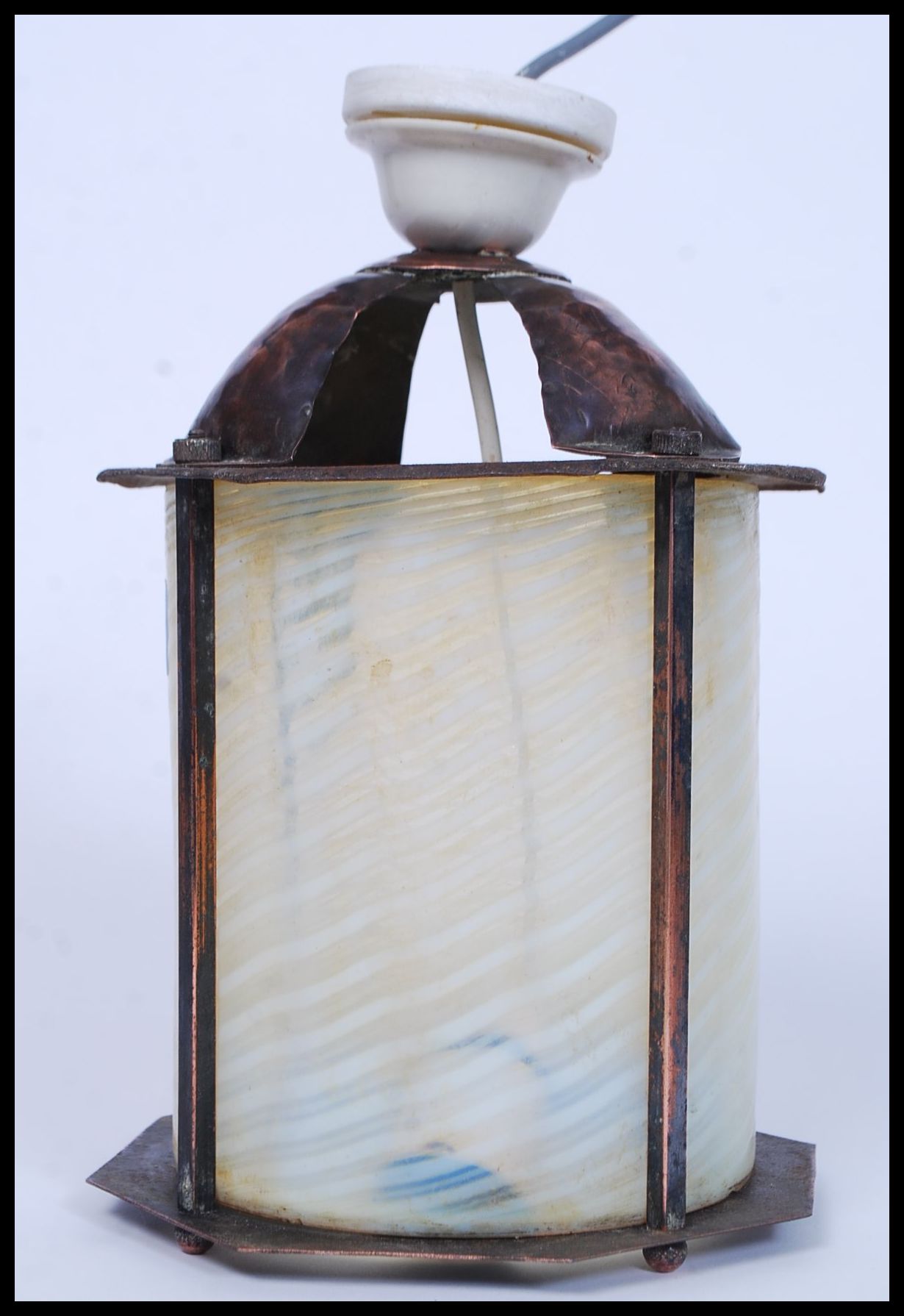 A vintage 20th century Arts & Crafts style copper lantern with coloured glass inset cylinder shade.
