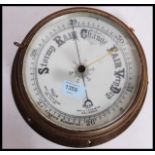 An early 20th century brass cased Bulkhead Aneroid Barometer,