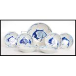 A collection of studio style blue and white ceramic Chinese bowls along with the serving bowl,