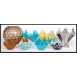 A collection of assorted glass / ceramic handkerchief vases.