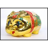 A 20th century Chinese ceramic statue money box in the form of a pig,