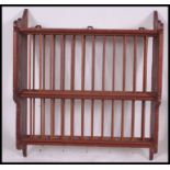 A 20th century country style pine wall mounted plate rack. The centre with spindle gallery supports.