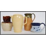 A collection of jugs to include a Players Please water jug, Wedgwood Bourn VIta jug,