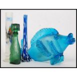 A collection of studio glass to include a fish, vases and a dog shaped glass decanter.