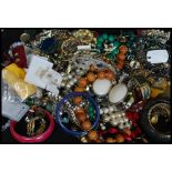 A collection of costume jewellery to include malachite mid century bead necklace, silver earrings,