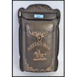 A cast iron 20th century letter box, with opening flap to top.