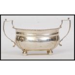 A solid silver twin handled large sugar bowl.