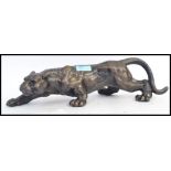 A 20th century cast iron lion figure - depicting a hunting lioness,
